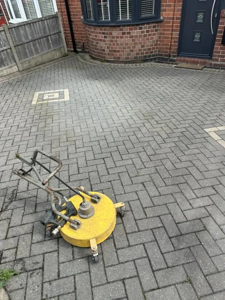 Professional surface cleaner at work on block paving